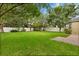Expansive backyard with lush green grass, mature trees, and a white picket fence for privacy at 1601 Stargazer Ter, Sanford, FL 32771