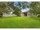 Spacious backyard featuring mature trees, a well-maintained lawn, and a partial view of the house at 1601 Stargazer Ter, Sanford, FL 32771
