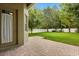 Paver patio and grassy backyard with privacy fence and mature trees, perfect for outdoor living at 1601 Stargazer Ter, Sanford, FL 32771