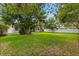 Lush backyard with mature trees, a green lawn, and partial views of the home's exterior at 1601 Stargazer Ter, Sanford, FL 32771