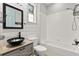 Well-lit bathroom features modern sink, a framed mirror, and a shower-tub combination at 1601 Stargazer Ter, Sanford, FL 32771