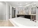 Bright bathroom featuring a luxurious soaking tub, dual vanities, and tile flooring at 1601 Stargazer Ter, Sanford, FL 32771