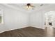 Spacious bedroom with hardwood floors, ceiling fan, neutral paint, and an arched doorway at 1601 Stargazer Ter, Sanford, FL 32771