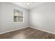 Bedroom featuring wood flooring, neutral walls, and a window providing natural light at 1601 Stargazer Ter, Sanford, FL 32771