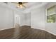 Neutral bedroom features wood flooring, tray ceiling, ceiling fan, and large windows at 1601 Stargazer Ter, Sanford, FL 32771