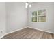 Cozy dining room features wood-look floors, a modern light fixture, and a large window at 1601 Stargazer Ter, Sanford, FL 32771