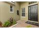 Inviting entryway with brick pavers, decorative fountain, and elegant front door at 1601 Stargazer Ter, Sanford, FL 32771