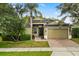 Lovely home features a brick driveway, well-manicured lawn, and an attached two-car garage at 1601 Stargazer Ter, Sanford, FL 32771
