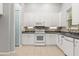 Well-lit kitchen with white cabinets, modern appliances, and stone backsplash at 1601 Stargazer Ter, Sanford, FL 32771
