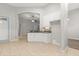 Bright open kitchen features white cabinets, stone backsplash, and tile flooring at 1601 Stargazer Ter, Sanford, FL 32771