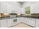 Kitchen featuring white cabinets, stone backsplash, stainless steel appliances, and modern fixtures at 1601 Stargazer Ter, Sanford, FL 32771