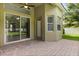 Charming patio with brick pavers, ceiling fan, and access to the backyard through sliding glass doors at 1601 Stargazer Ter, Sanford, FL 32771