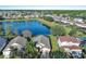 Aerial view of the home in a residential neighborhood backing to a lake at 16741 Rising Star Dr, Clermont, FL 34714