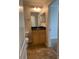 Bathroom featuring a wooden vanity with granite countertop and adjacent toilet at 2007 Dixie Belle Dr # 2007 M, Orlando, FL 32812