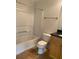 Full bathroom with a shower-tub combo, toilet, and wooden vanity with black countertop at 2007 Dixie Belle Dr # 2007 M, Orlando, FL 32812