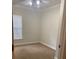 Cozy bedroom features neutral carpet, a ceiling fan, and a window with blinds for natural light at 2007 Dixie Belle Dr # 2007 M, Orlando, FL 32812