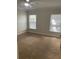 Bright bedroom featuring two large windows and neutral carpeted floors at 2007 Dixie Belle Dr # 2007 M, Orlando, FL 32812