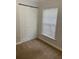 This bedroom offers a window with blinds and a closet for storage at 2007 Dixie Belle Dr # 2007 M, Orlando, FL 32812