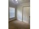 This bedroom has a window with blinds and a closet for storage at 2007 Dixie Belle Dr # 2007 M, Orlando, FL 32812