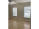 This bedroom features neutral tile and two windows with blinds for natural light at 2007 Dixie Belle Dr # 2007 M, Orlando, FL 32812