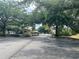 Gated community entrance with secure access and mature trees at 2007 Dixie Belle Dr # 2007 M, Orlando, FL 32812