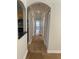 Hallway view into kitchen and to the living room with natural light and wide trim at 2007 Dixie Belle Dr # 2007 M, Orlando, FL 32812
