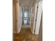 Hallway with multiple closets providing plenty of storage space and leading into living area at 2007 Dixie Belle Dr # 2007 M, Orlando, FL 32812