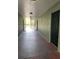 Hallway of condo building with exterior entrance and multiple apartment doors at 2007 Dixie Belle Dr # 2007 M, Orlando, FL 32812