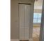 Hallway closet with bi-fold doors with an adjacent room with natural light at 2007 Dixie Belle Dr # 2007 M, Orlando, FL 32812