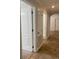 Hallway with stone tile and white trim leading to various rooms for easy navigation at 2007 Dixie Belle Dr # 2007 M, Orlando, FL 32812