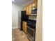 This kitchen has stainless steel appliances, wooden cabinets, and dark countertops at 2007 Dixie Belle Dr # 2007 M, Orlando, FL 32812