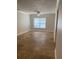 Bright living room boasts tile floors, a ceiling fan, and ample natural light from a large window at 2007 Dixie Belle Dr # 2007 M, Orlando, FL 32812