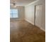 Bright living room features a ceiling fan, large window, and a white entry door at 2007 Dixie Belle Dr # 2007 M, Orlando, FL 32812