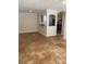 Living room with kitchen view, showcasing open and tiled floors at 2007 Dixie Belle Dr # 2007 M, Orlando, FL 32812