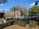 Community pool area with shade trees and umbrellas, tables and lounge chairs at 2007 Dixie Belle Dr # 2007 M, Orlando, FL 32812