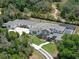 Aerial view showcasing the property's layout, including the pool, landscaping, and ample parking at 20199 Sweetwood Ln, Clermont, FL 34715
