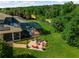 Expansive backyard with screened pool, fire pit, and lush green lawn at 20199 Sweetwood Ln, Clermont, FL 34715