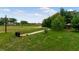 Spacious grassy backyard with mature landscaping and walking paths to the fire pit at 20199 Sweetwood Ln, Clermont, FL 34715
