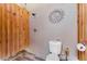 Rustic outdoor bathroom with shower, toilet, wooden privacy screen, and decorative sun adornment at 20199 Sweetwood Ln, Clermont, FL 34715