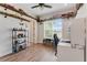 Bedroom featuring shelves displaying toys, a desk, and a large window with natural light at 20199 Sweetwood Ln, Clermont, FL 34715