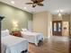 Comfortable bedroom with wood flooring and a ceiling fan at 20199 Sweetwood Ln, Clermont, FL 34715