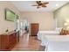 Spacious bedroom featuring two twin beds, wooden floors, and a ceiling fan at 20199 Sweetwood Ln, Clermont, FL 34715