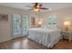 Bright bedroom with a bed, access to the balcony and views of nature at 20199 Sweetwood Ln, Clermont, FL 34715