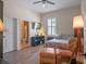 Cozy bedroom with a leather chair and a connected bathroom with a tile shower at 20199 Sweetwood Ln, Clermont, FL 34715