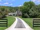 Charming home exterior featuring a long driveway and well-manicured lawn at 20199 Sweetwood Ln, Clermont, FL 34715