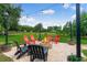Cozy outdoor fire pit with ample seating and string lights for evening gatherings at 20199 Sweetwood Ln, Clermont, FL 34715
