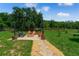 Inviting backyard fire pit area with Adirondack chairs, perfect for outdoor entertaining at 20199 Sweetwood Ln, Clermont, FL 34715