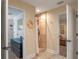 Hallway between two rooms with a tiled shower stall and neutral colored walls at 20199 Sweetwood Ln, Clermont, FL 34715
