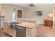 Open concept kitchen with stainless steel sink, granite countertops, and adjacent living area at 20199 Sweetwood Ln, Clermont, FL 34715