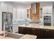 This gourmet kitchen boasts stainless appliances, custom cabinetry, granite counters and stylish backsplash at 20199 Sweetwood Ln, Clermont, FL 34715
